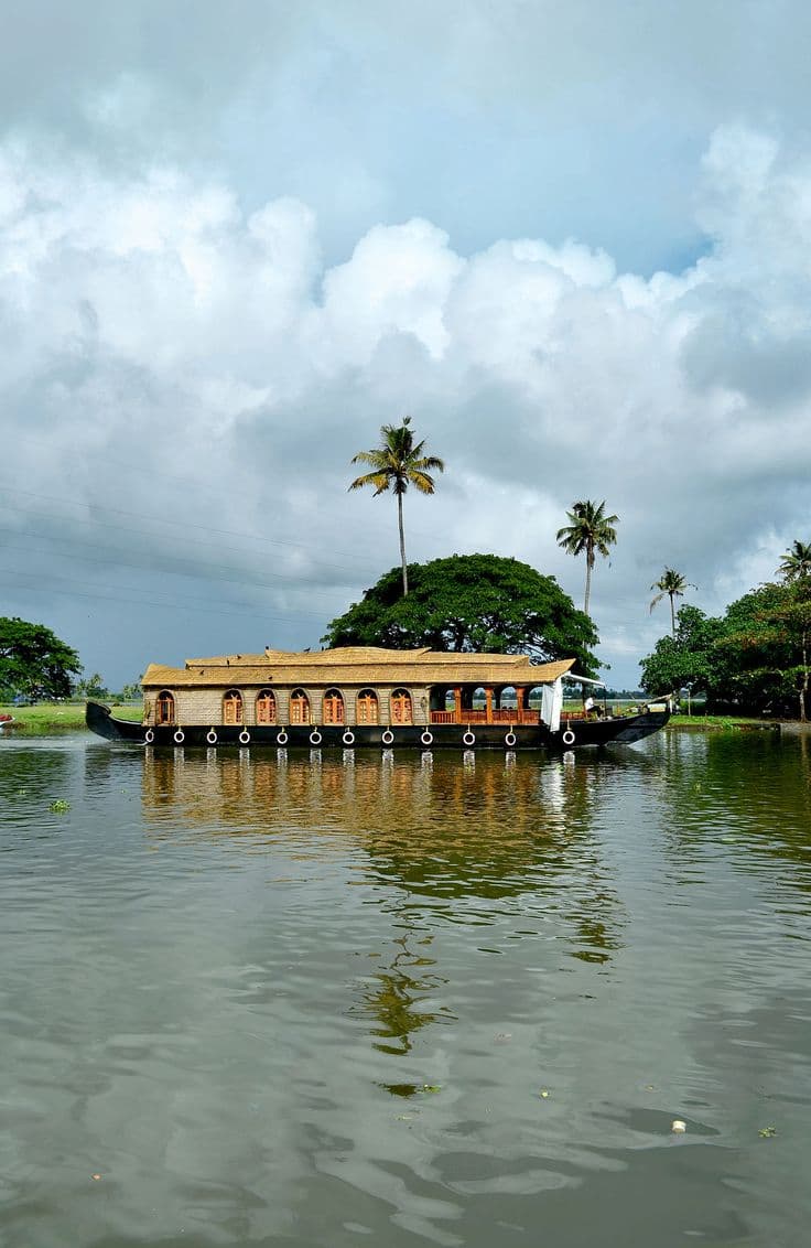Scenic view of Kumarakom backwaters, luxurious lakefront resorts, and lush green nature landscapes